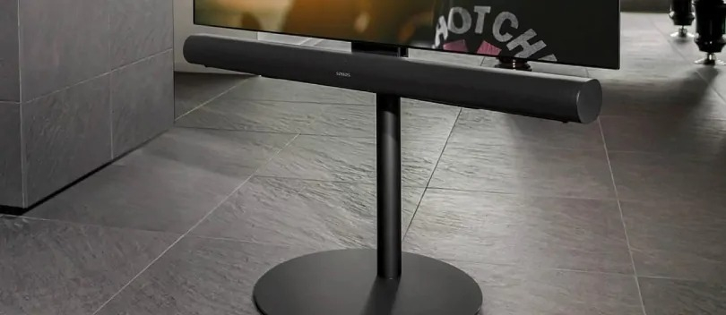Soundbar is suspended below the TV by means of a TV stand.
